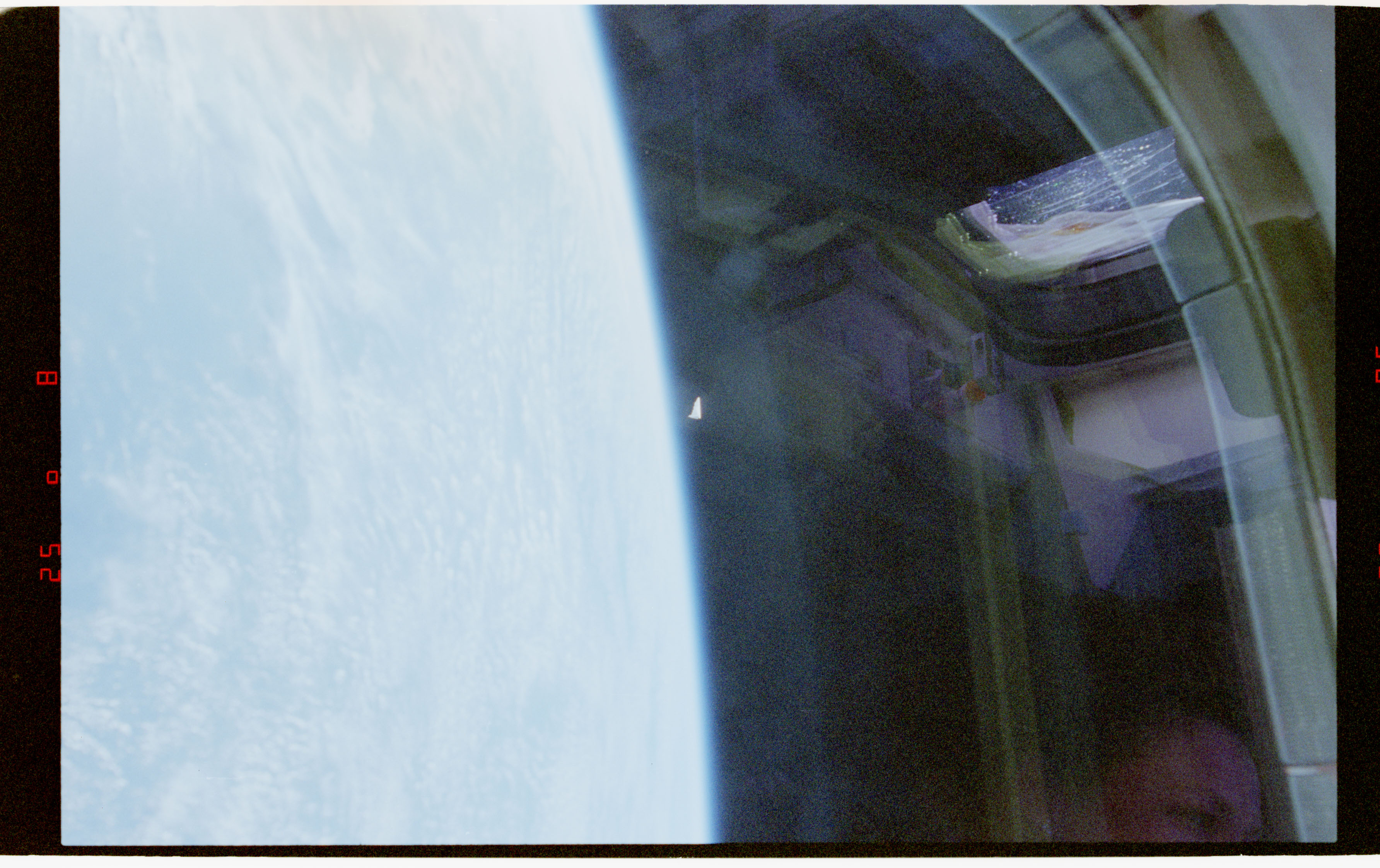 STS-80 Rotating Object Over Earth, 1996